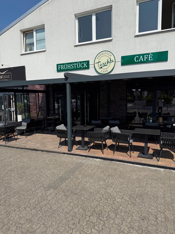 Taschte Café von außen mit Terrasse und Frühstück-Café-Schild